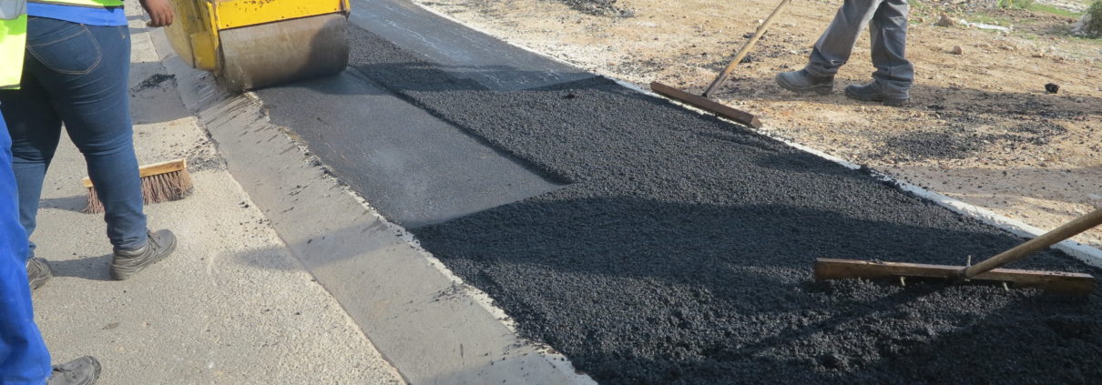 Road crew laying fresh asphalt